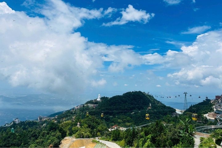 Tourists exploring the iconic Golden Bridge at Ba Na Hills, Vietnam, with its unique hand-shaped supports, photo 7 | wizardtrip