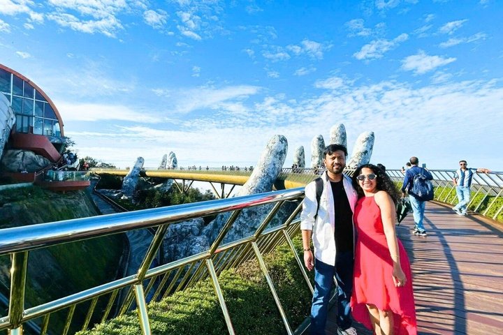 Tourists exploring the iconic Golden Bridge at Ba Na Hills, Vietnam, with its unique hand-shaped supports, photo 10 | wizardtrip