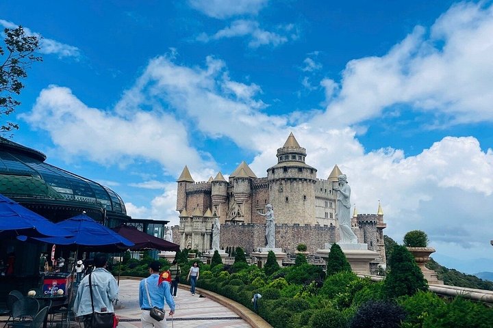 Tourists exploring the iconic Golden Bridge at Ba Na Hills, Vietnam, with its unique hand-shaped supports, photo 14 | wizardtrip