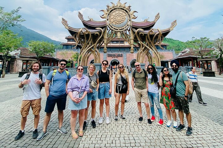 Tourists exploring the iconic Golden Bridge at Ba Na Hills, Vietnam, with its unique hand-shaped supports, photo 17 | wizardtrip