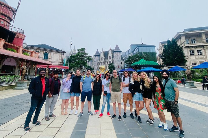 Tourists exploring the iconic Golden Bridge at Ba Na Hills, Vietnam, with its unique hand-shaped supports, photo 23 | wizardtrip