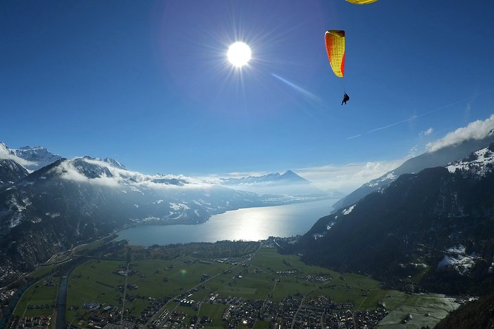 Tandem paragliding flight over the Swiss Alps near Interlaken, offering stunning mountain and lake views, photo 6 | wizardtrip
