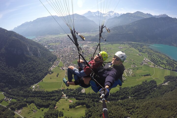 Tandem paragliding flight over the Swiss Alps near Interlaken, offering stunning mountain and lake views, photo 7 | wizardtrip