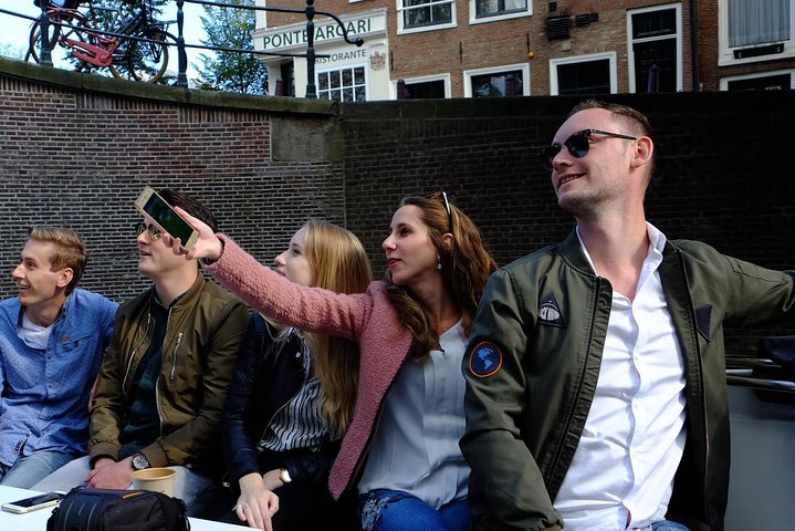 Enjoy a scenic small-group canal cruise in Amsterdam, complete with snacks and drinks, photo 7 | wizardtrip