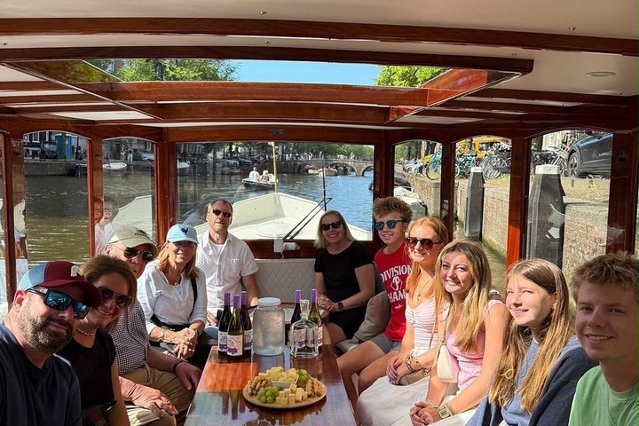 Enjoy a scenic small-group canal cruise in Amsterdam, complete with snacks and drinks, photo 13 | wizardtrip