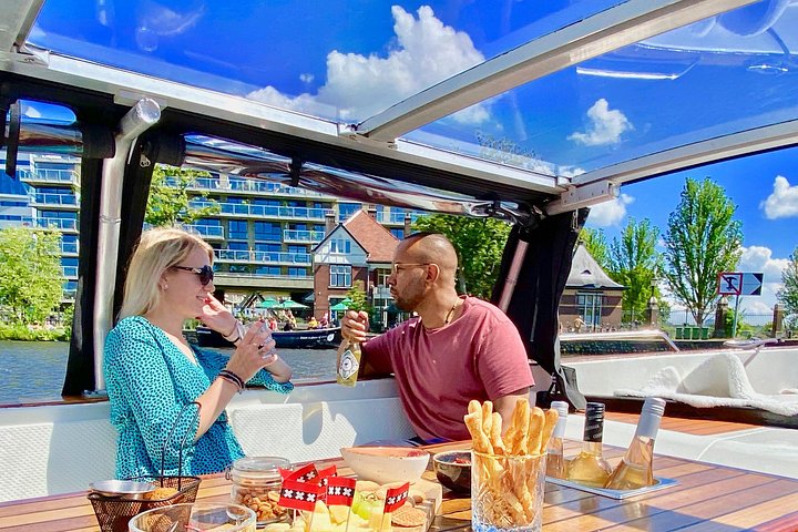 Enjoy a scenic small-group canal cruise in Amsterdam, complete with snacks and drinks, photo 20 | wizardtrip
