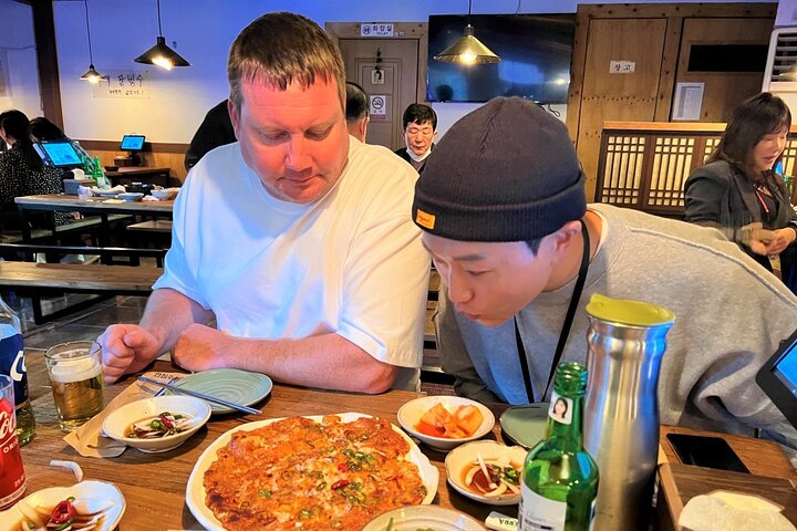 Private tour exploring Busan's landmarks like temples, markets, and coastal views, photo 41 | wizardtrip