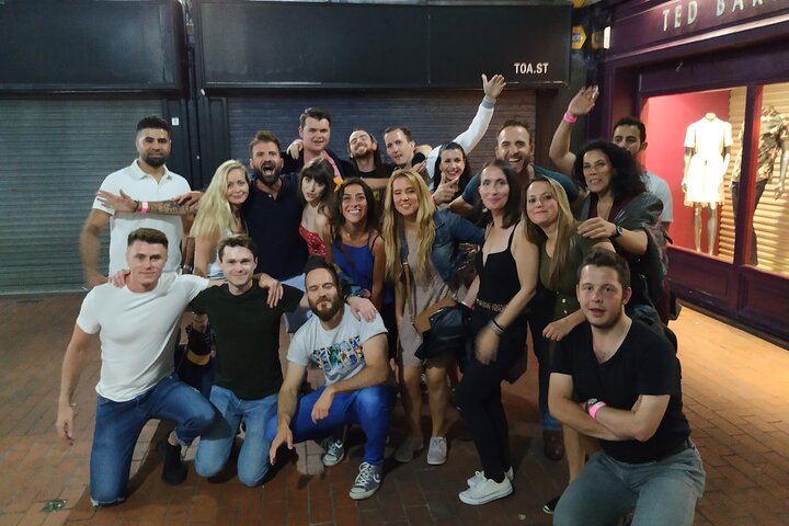 A lively pub crawl experience in Palermo, Sicily, with groups enjoying drinks and socializing in local bars, photo 6 | wizardtrip
