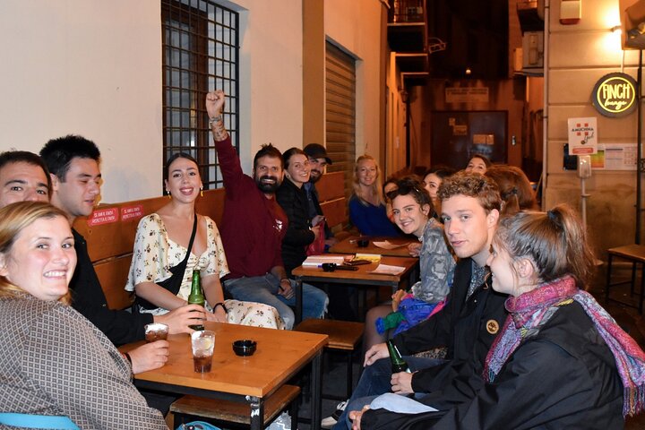 A lively pub crawl experience in Palermo, Sicily, with groups enjoying drinks and socializing in local bars, photo 7 | wizardtrip