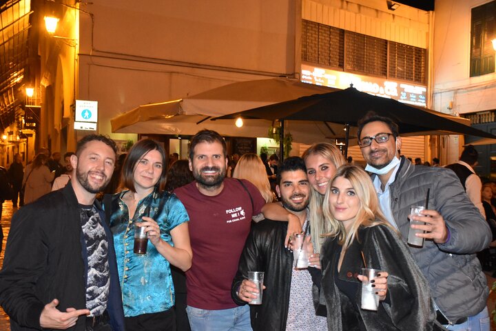 A lively pub crawl experience in Palermo, Sicily, with groups enjoying drinks and socializing in local bars, photo 8 | wizardtrip