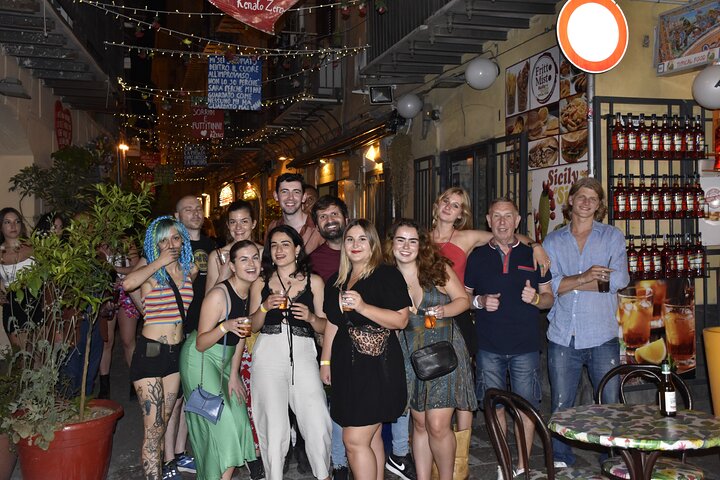 A lively pub crawl experience in Palermo, Sicily, with groups enjoying drinks and socializing in local bars, photo 9 | wizardtrip