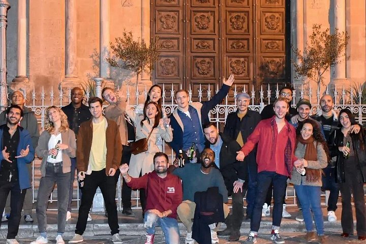A lively pub crawl experience in Palermo, Sicily, with groups enjoying drinks and socializing in local bars, photo 12 | wizardtrip