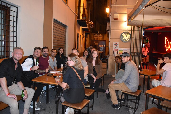 A lively pub crawl experience in Palermo, Sicily, with groups enjoying drinks and socializing in local bars, photo 15 | wizardtrip