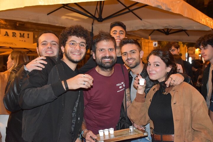 A lively pub crawl experience in Palermo, Sicily, with groups enjoying drinks and socializing in local bars, photo 17 | wizardtrip