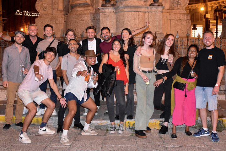 A lively pub crawl experience in Palermo, Sicily, with groups enjoying drinks and socializing in local bars, photo 18 | wizardtrip