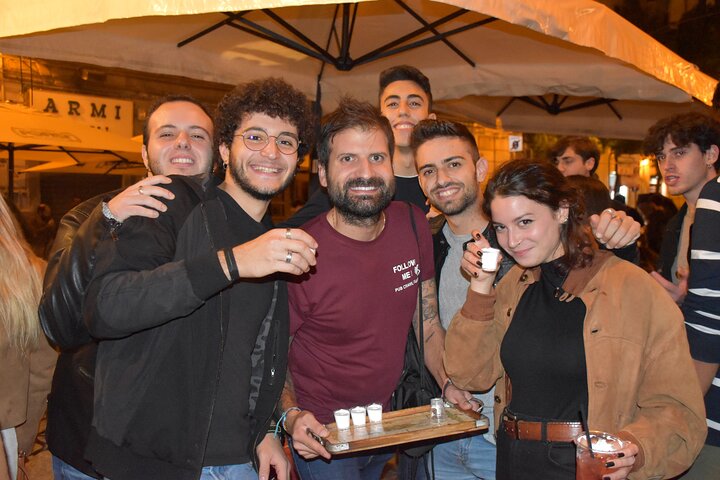 A lively pub crawl experience in Palermo, Sicily, with groups enjoying drinks and socializing in local bars, photo 21 | wizardtrip