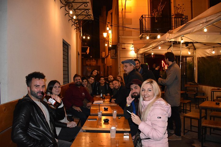 A lively pub crawl experience in Palermo, Sicily, with groups enjoying drinks and socializing in local bars, photo 22 | wizardtrip