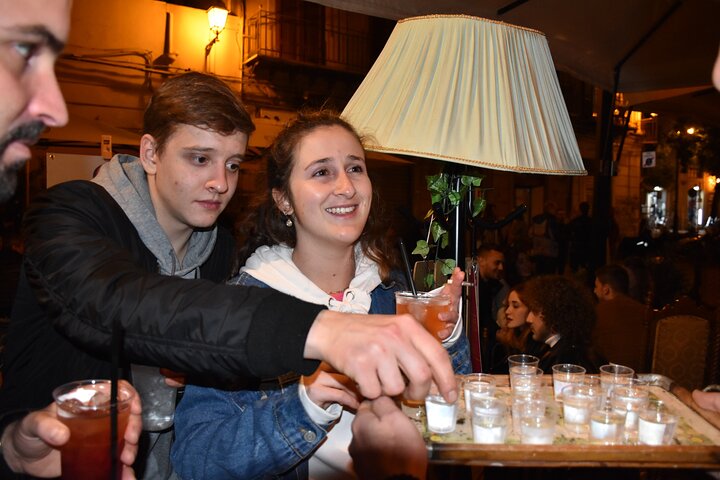 A lively pub crawl experience in Palermo, Sicily, with groups enjoying drinks and socializing in local bars, photo 24 | wizardtrip