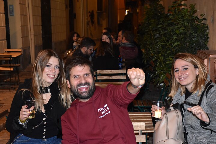 A lively pub crawl experience in Palermo, Sicily, with groups enjoying drinks and socializing in local bars, photo 25 | wizardtrip