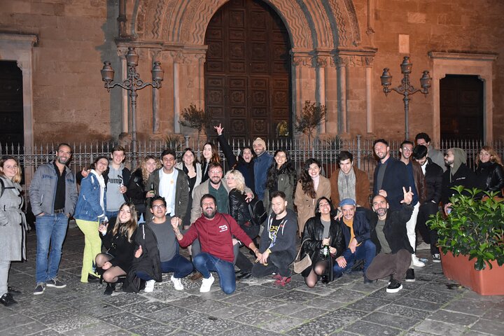 A lively pub crawl experience in Palermo, Sicily, with groups enjoying drinks and socializing in local bars, photo 26 | wizardtrip