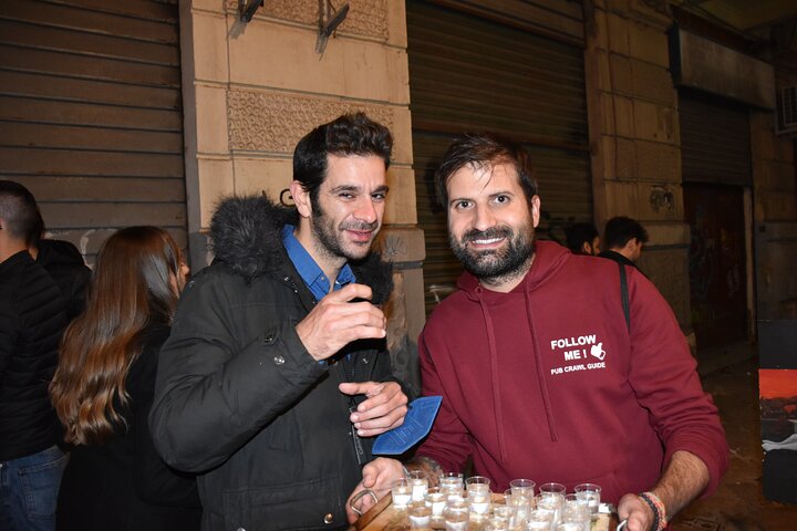 A lively pub crawl experience in Palermo, Sicily, with groups enjoying drinks and socializing in local bars, photo 27 | wizardtrip