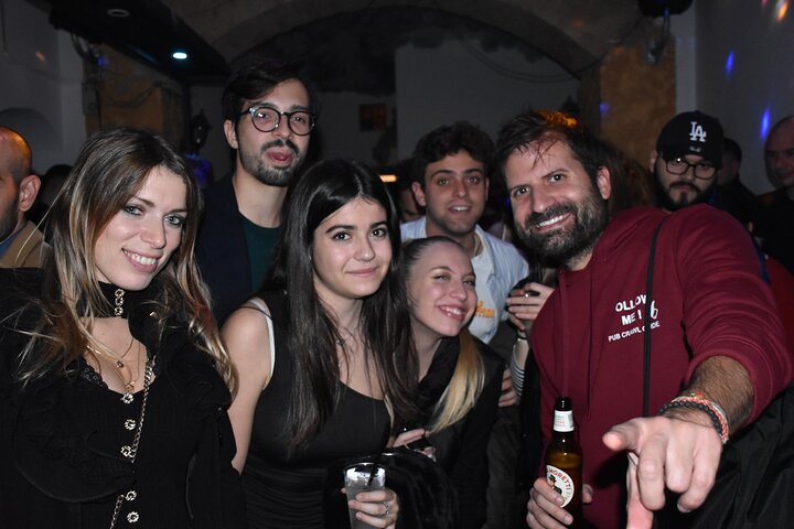 A lively pub crawl experience in Palermo, Sicily, with groups enjoying drinks and socializing in local bars, photo 28 | wizardtrip