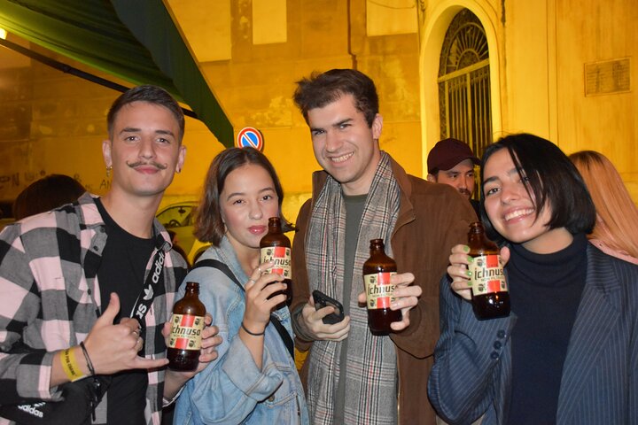 A lively pub crawl experience in Palermo, Sicily, with groups enjoying drinks and socializing in local bars, photo 29 | wizardtrip