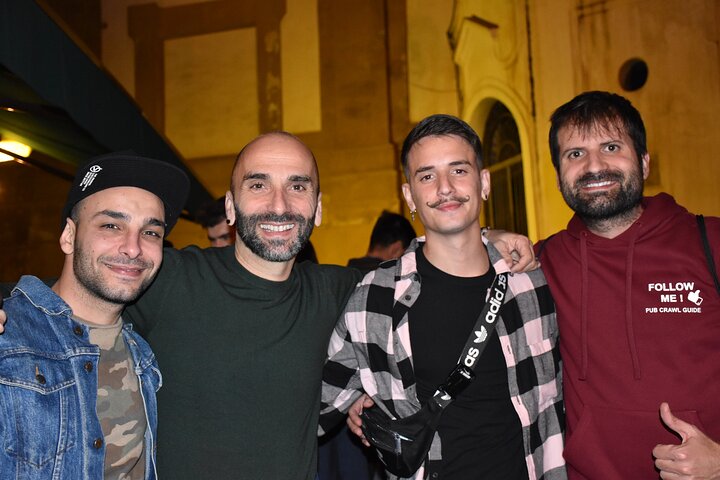 A lively pub crawl experience in Palermo, Sicily, with groups enjoying drinks and socializing in local bars, photo 30 | wizardtrip