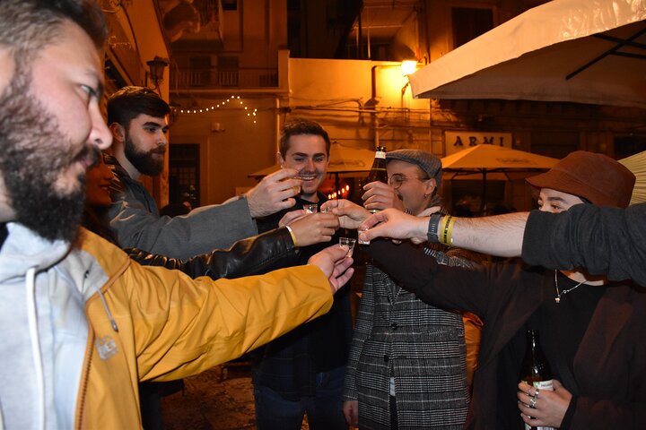 A lively pub crawl experience in Palermo, Sicily, with groups enjoying drinks and socializing in local bars, photo 34 | wizardtrip