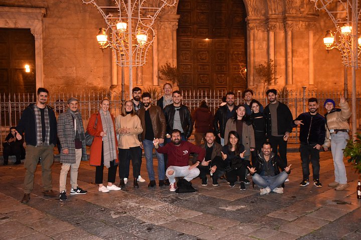A lively pub crawl experience in Palermo, Sicily, with groups enjoying drinks and socializing in local bars, photo 36 | wizardtrip
