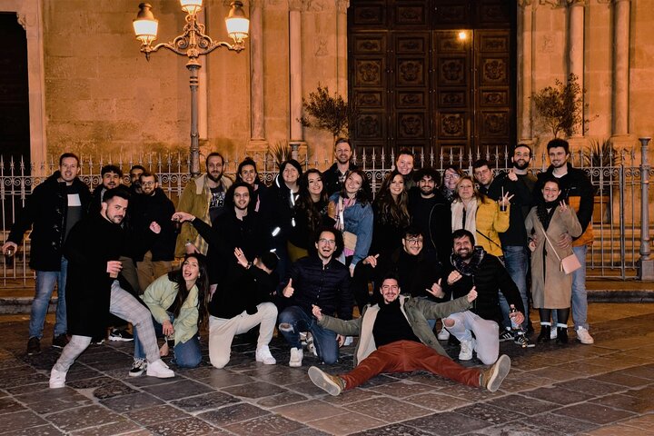 A lively pub crawl experience in Palermo, Sicily, with groups enjoying drinks and socializing in local bars, photo 38 | wizardtrip