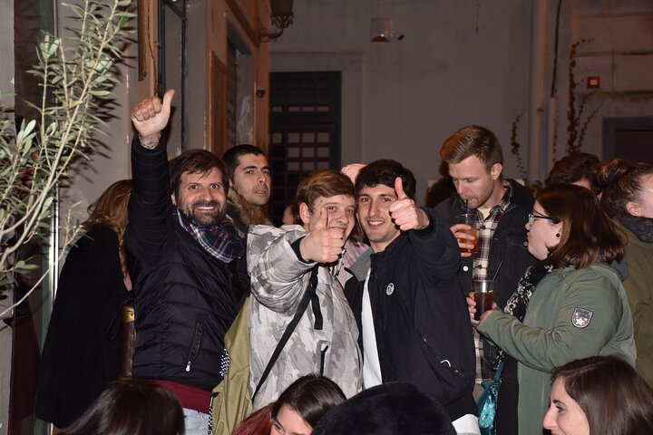 A lively pub crawl experience in Palermo, Sicily, with groups enjoying drinks and socializing in local bars, photo 39 | wizardtrip