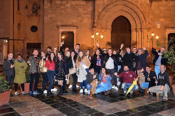 A lively pub crawl experience in Palermo, Sicily, with groups enjoying drinks and socializing in local bars, photo 40 | wizardtrip