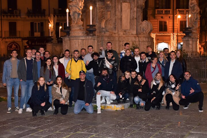 A lively pub crawl experience in Palermo, Sicily, with groups enjoying drinks and socializing in local bars, photo 41 | wizardtrip