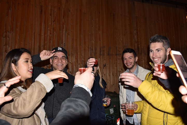 A lively pub crawl experience in Palermo, Sicily, with groups enjoying drinks and socializing in local bars, photo 44 | wizardtrip