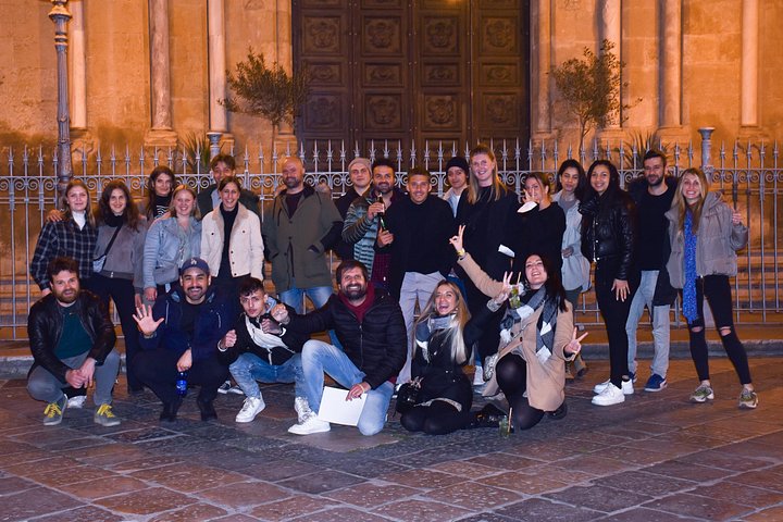 A lively pub crawl experience in Palermo, Sicily, with groups enjoying drinks and socializing in local bars, photo 46 | wizardtrip