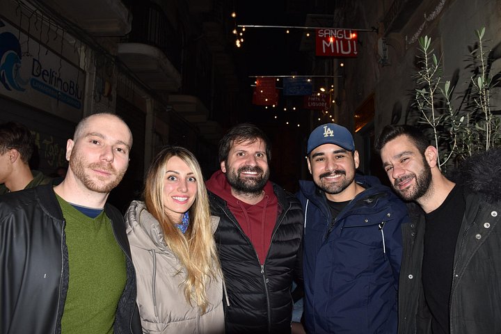 A lively pub crawl experience in Palermo, Sicily, with groups enjoying drinks and socializing in local bars, photo 47 | wizardtrip