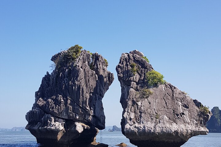 A scenic day tour of Halong Bay, Vietnam, featuring limestone karsts, emerald waters, and traditional boats, photo 12 | wizardtrip