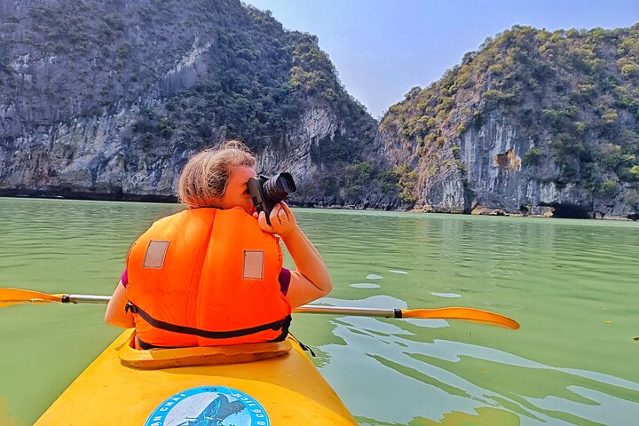 A scenic day tour of Halong Bay, Vietnam, featuring limestone karsts, emerald waters, and traditional boats, photo 18 | wizardtrip