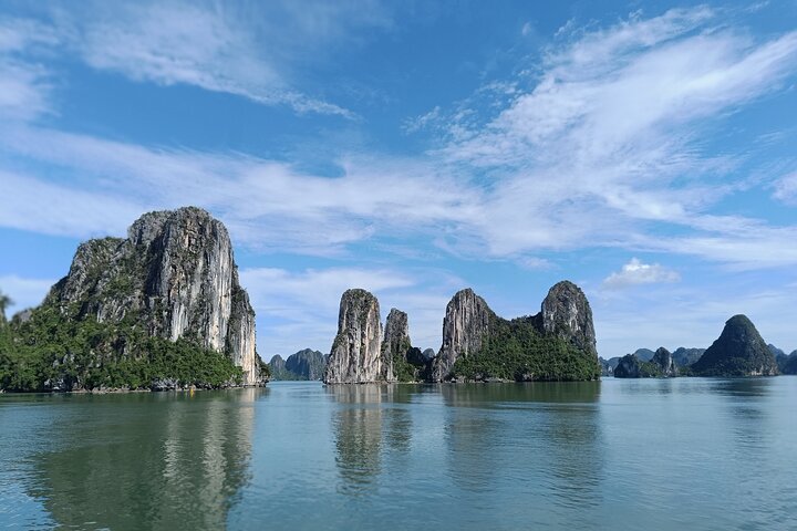 A scenic day tour of Halong Bay, Vietnam, featuring limestone karsts, emerald waters, and traditional boats, photo 23 | wizardtrip