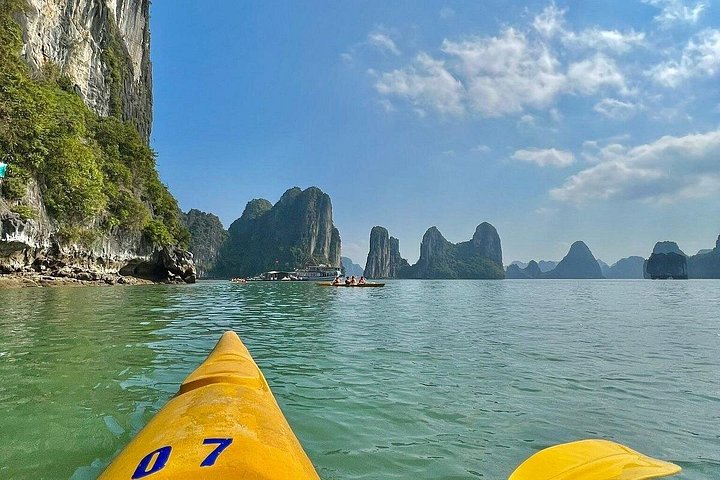 A scenic day tour of Halong Bay, Vietnam, featuring limestone karsts, emerald waters, and traditional boats, photo 24 | wizardtrip
