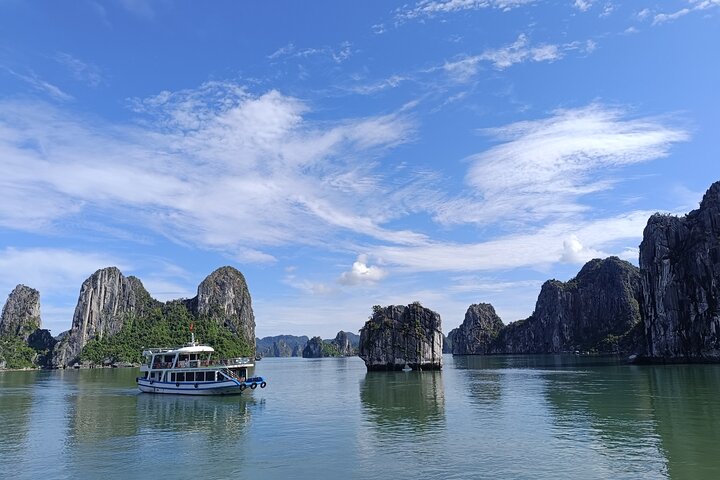 A scenic day tour of Halong Bay, Vietnam, featuring limestone karsts, emerald waters, and traditional boats, photo 27 | wizardtrip