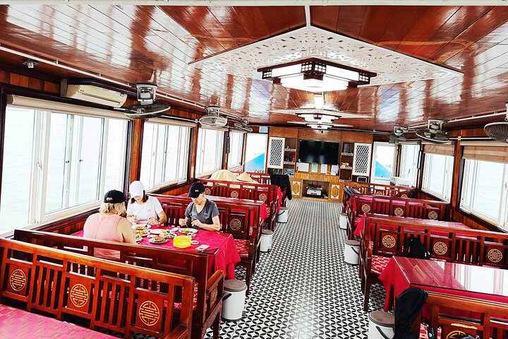 A scenic day tour of Halong Bay, Vietnam, featuring limestone karsts, emerald waters, and traditional boats, photo 37 | wizardtrip