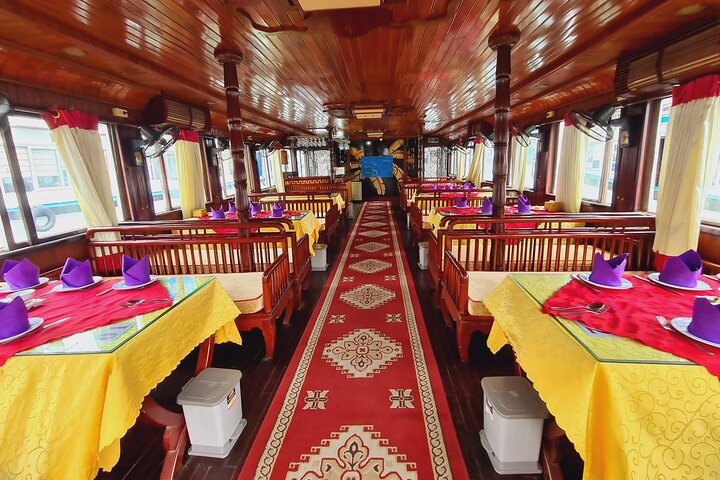 A scenic day tour of Halong Bay, Vietnam, featuring limestone karsts, emerald waters, and traditional boats, photo 40 | wizardtrip
