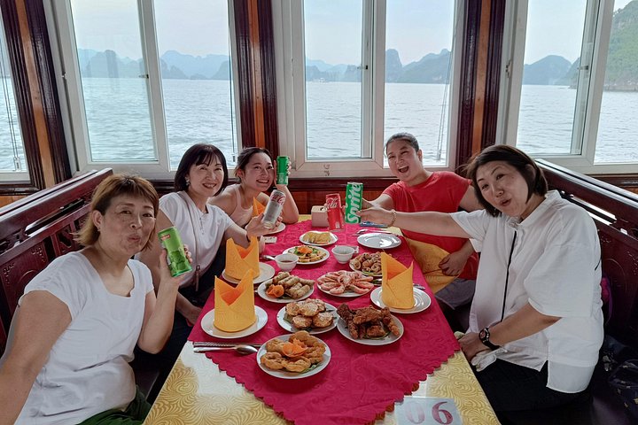 A scenic day tour of Halong Bay, Vietnam, featuring limestone karsts, emerald waters, and traditional boats, photo 41 | wizardtrip