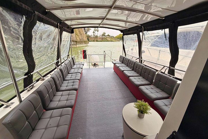 Enjoy a scenic boat tour on the Guadalquivir River in Seville, passing by landmarks like Torre del Oro and Triana Bridge, photo 8 | wizardtrip