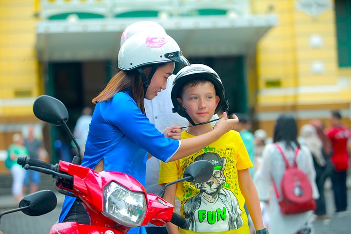 Experience Ho Chi Minh City's vibrant nightlife on a motorbike tour with a female guide, tasting local snacks and seeing city lights, photo 6 | wizardtrip