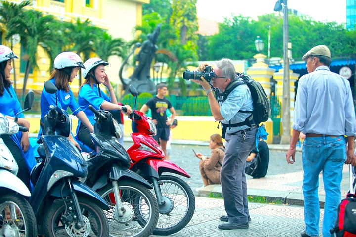 Experience Ho Chi Minh City's vibrant nightlife on a motorbike tour with a female guide, tasting local snacks and seeing city lights, photo 7 | wizardtrip