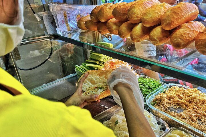 Experience Ho Chi Minh City's vibrant nightlife on a motorbike tour with a female guide, tasting local snacks and seeing city lights, photo 9 | wizardtrip