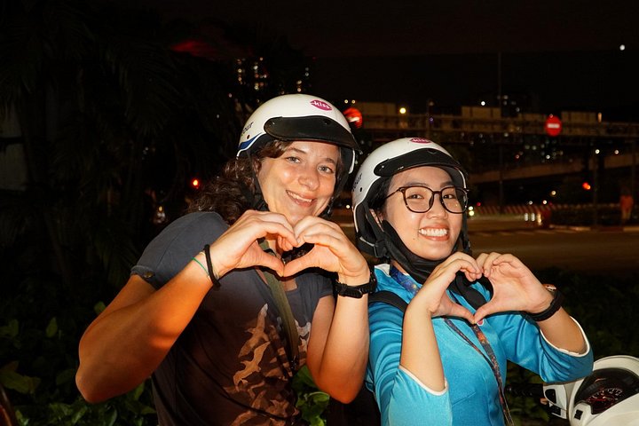 Experience Ho Chi Minh City's vibrant nightlife on a motorbike tour with a female guide, tasting local snacks and seeing city lights, photo 12 | wizardtrip